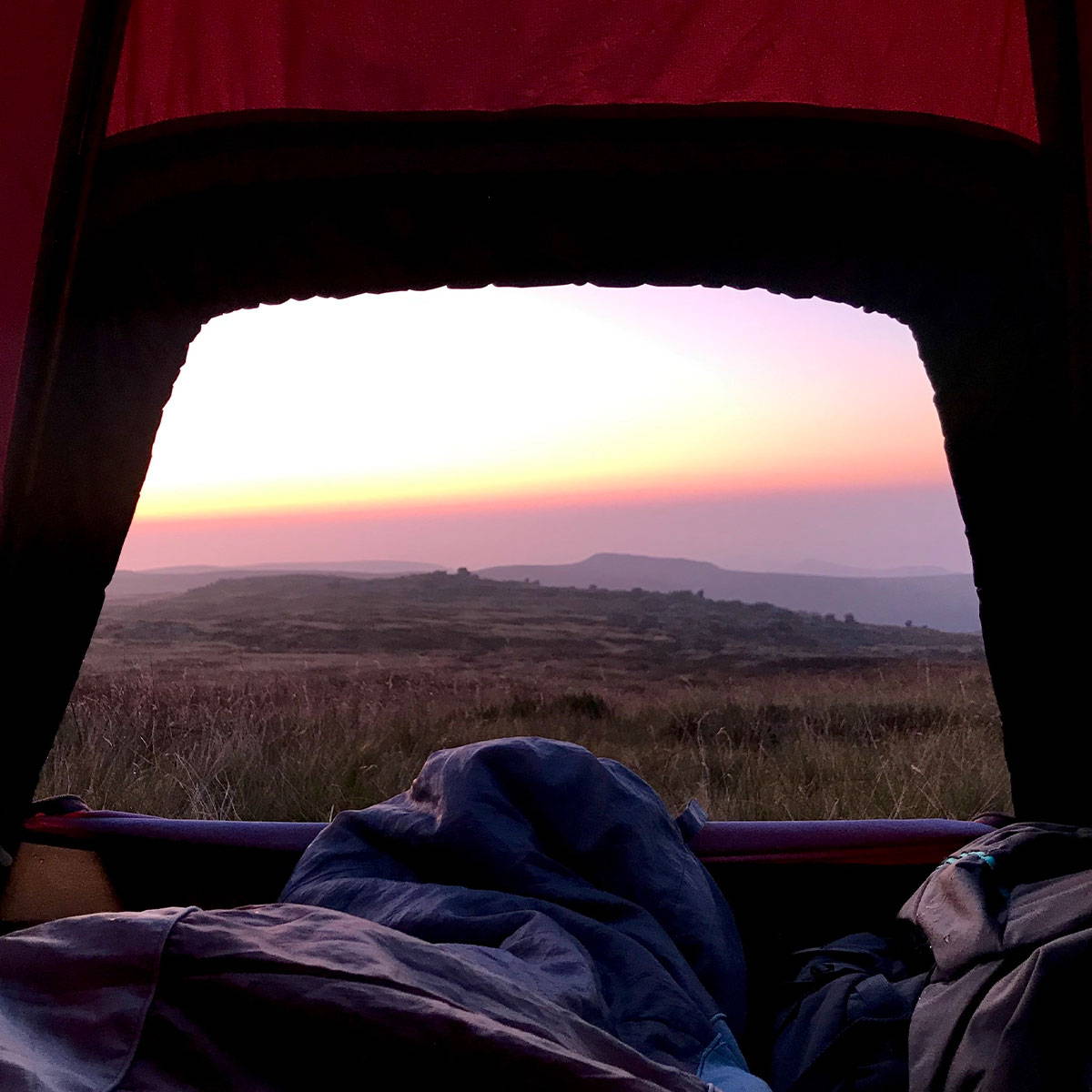 An image showing a beautiful view from inside a tent whilst wild camping. Taken by 3RD ROCK's creative director Grace.