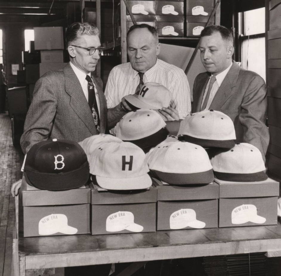 3 men talk about hats