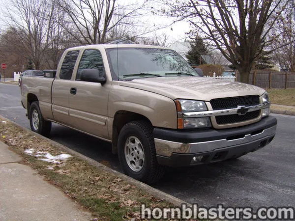 Front three-quarter Joe's tan 2004 Chevy Silverado extended cab parked on residential street photo 1