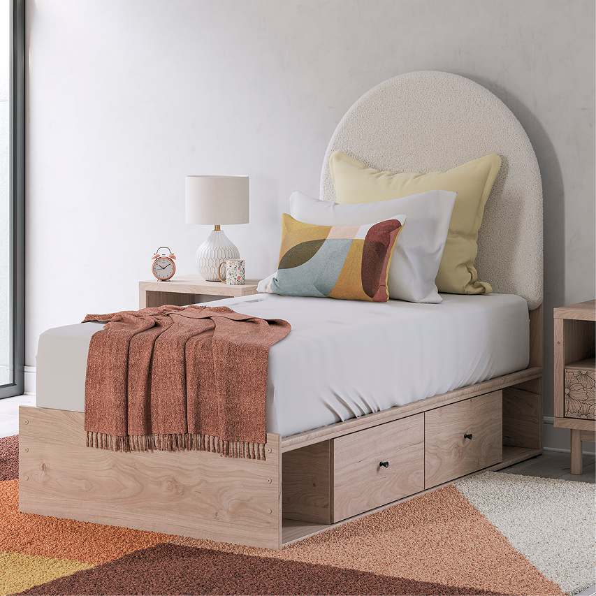 Bedroom featuring a kids storage bed, colorful accent pillows, and layered textiles.