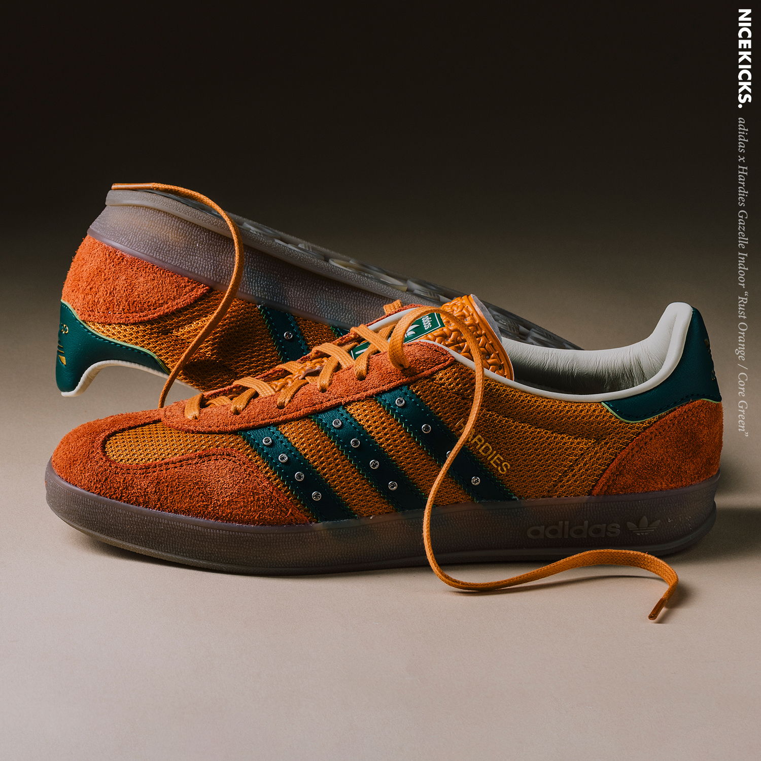 Orange and green suede sneakers with laces, displayed against a neutral background.