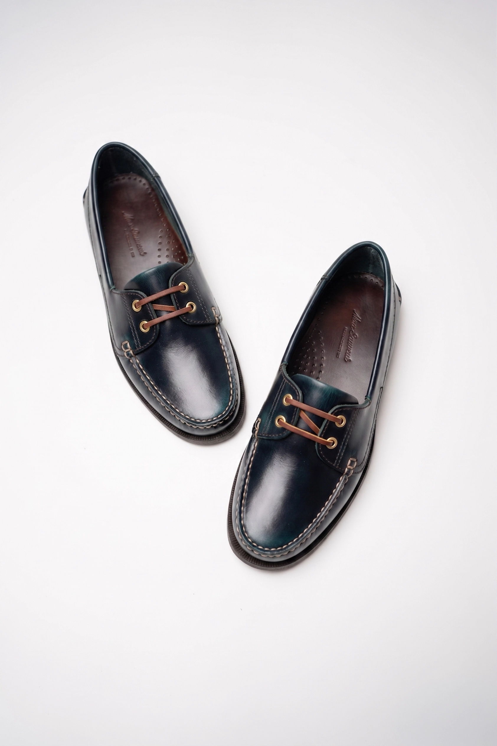 Pair of dark leather shoes with laces, displayed against a white background.