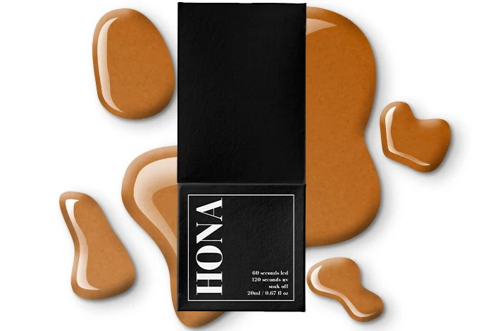 A cosmetics product with a black box and liquid foundation splatters.