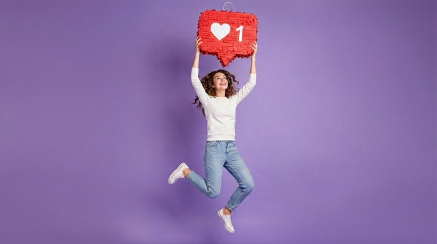 Person jumping with a heart emoji sign against a purple background.