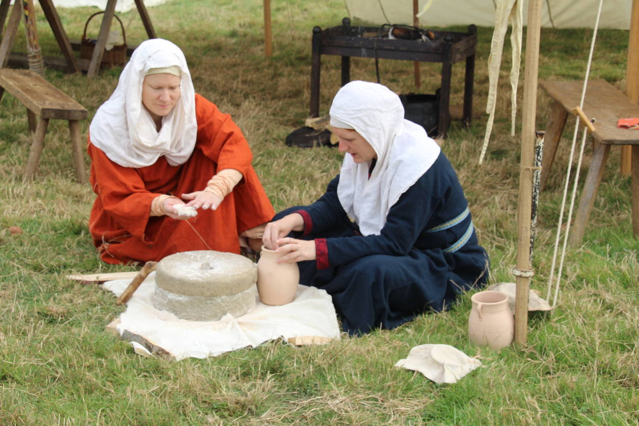 A reenactment of Anglo-Saxon women making flour