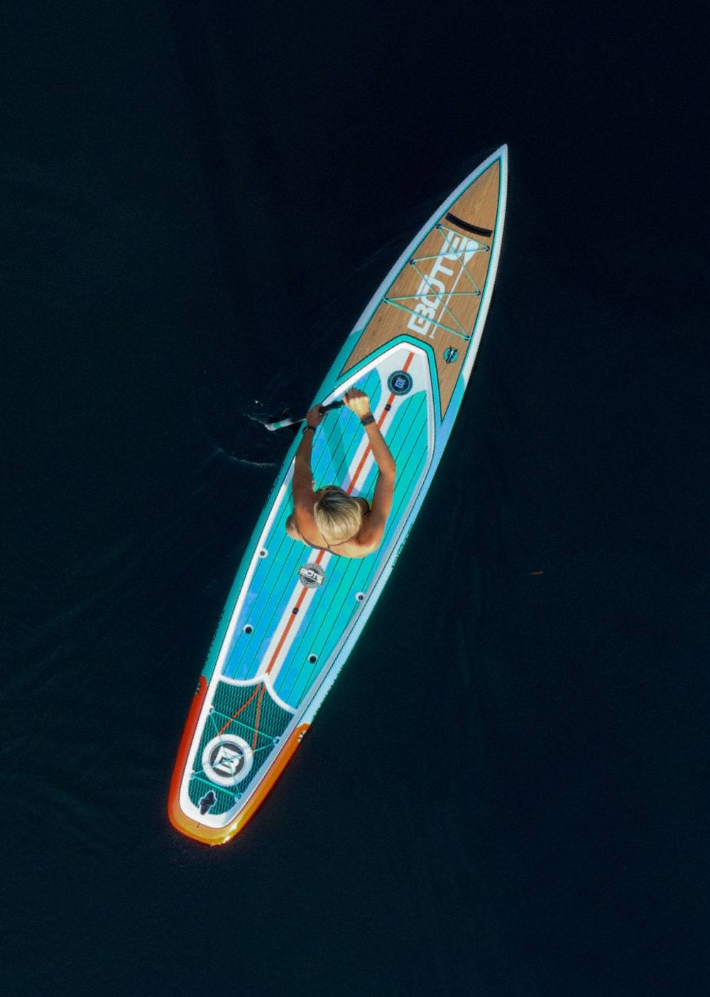Overhead view of a woman paddling her Traveller Classic Teak