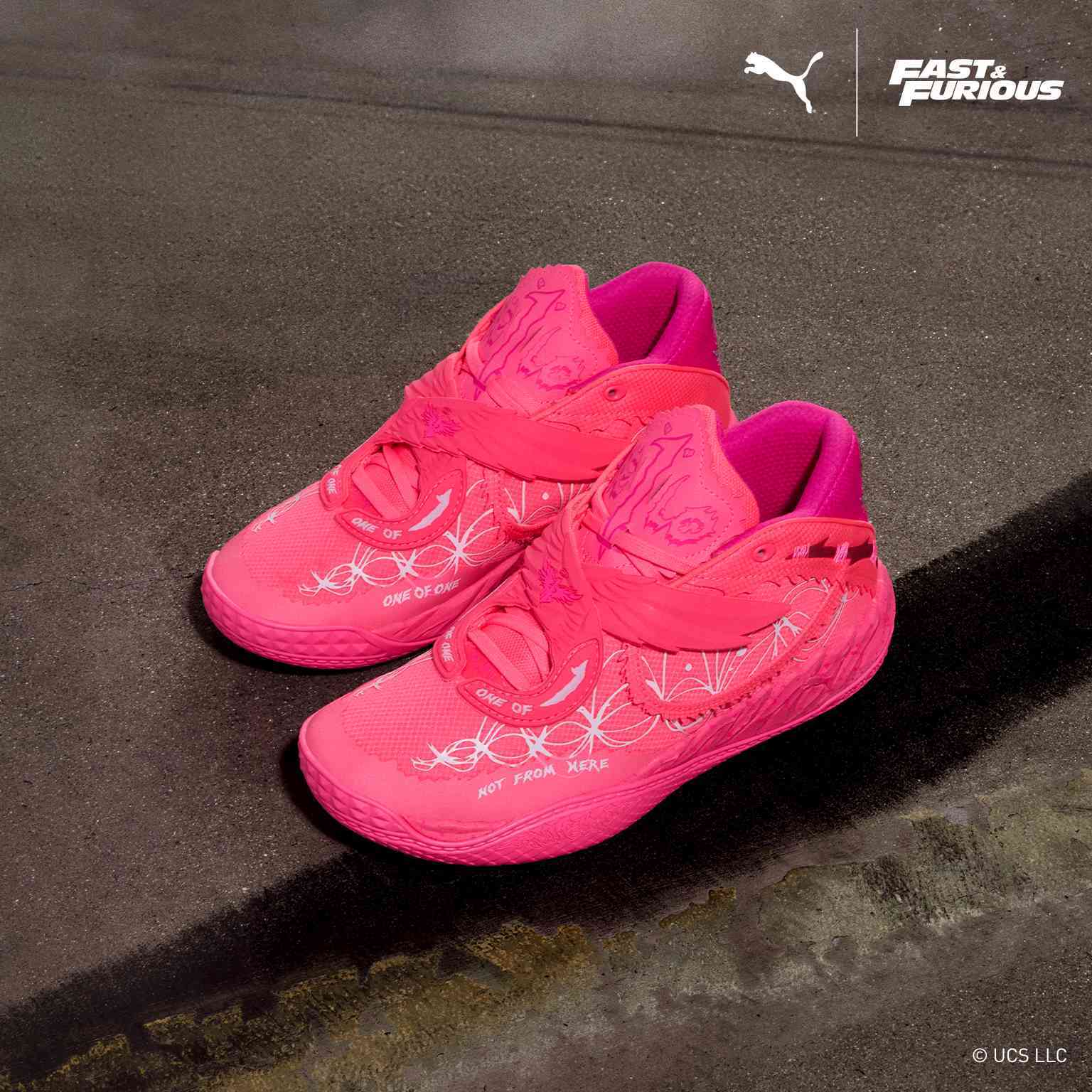 Puma x Fast and Furious - A pair of vibrant pink Puma sneakers on a concrete surface.