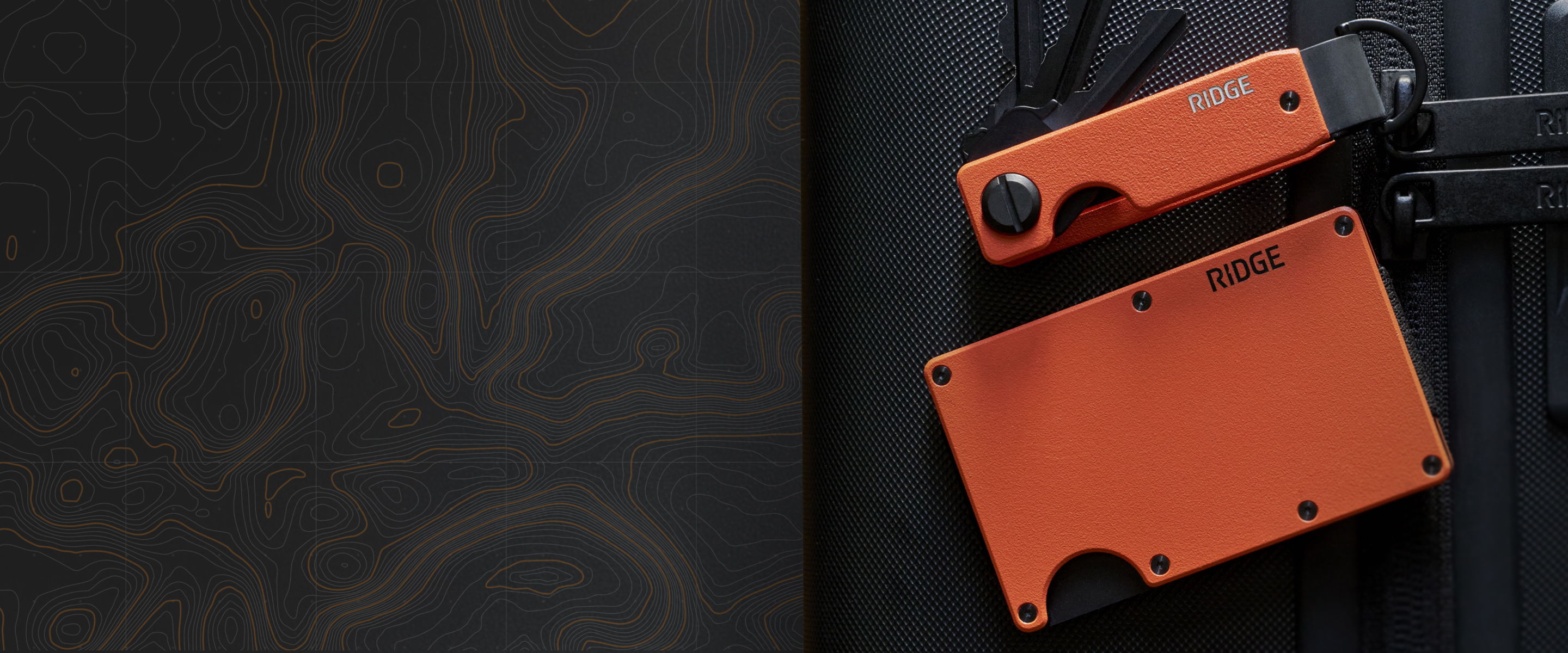 Orange knife and wallet on a dark background.