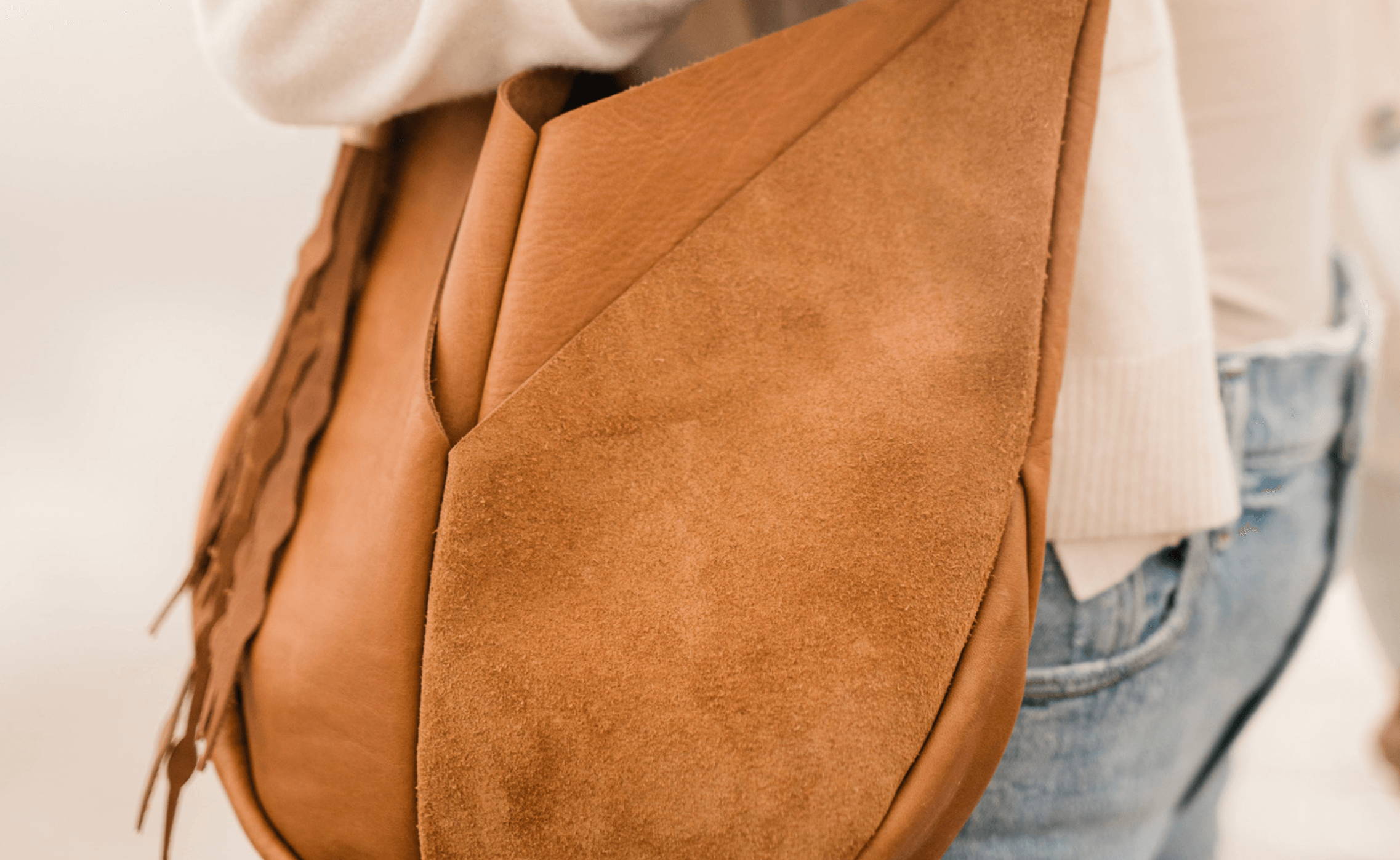 close up of suede on beach nut leather bag