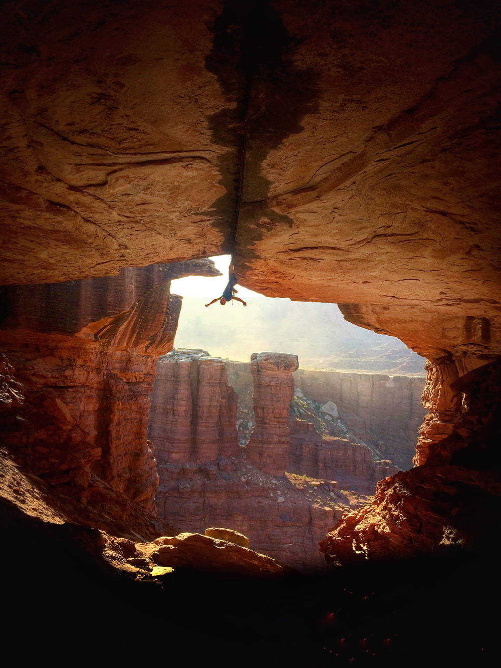 Climber posing upside down in Red Rocks