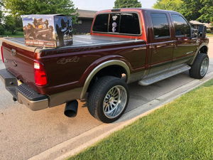 Maroon and tan 2006 Ford F250 King Ranch Super Duty with HornBlasters Outlaw train horn box on the bed