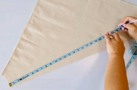 Marking the 24-inch bag dimensions from the stem hole using a measuring tape