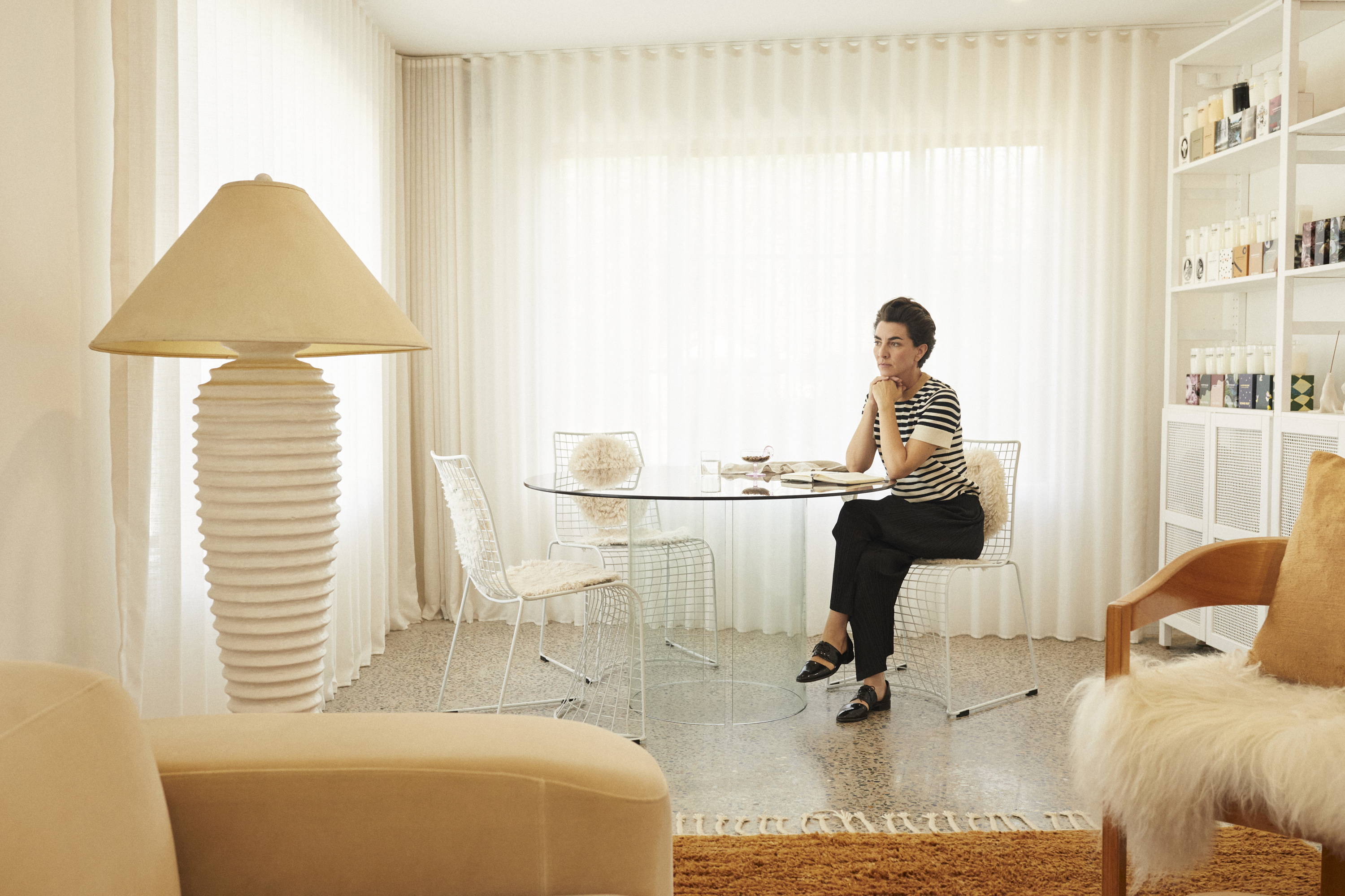 Elise Balzac sitting on a chair at a desk.