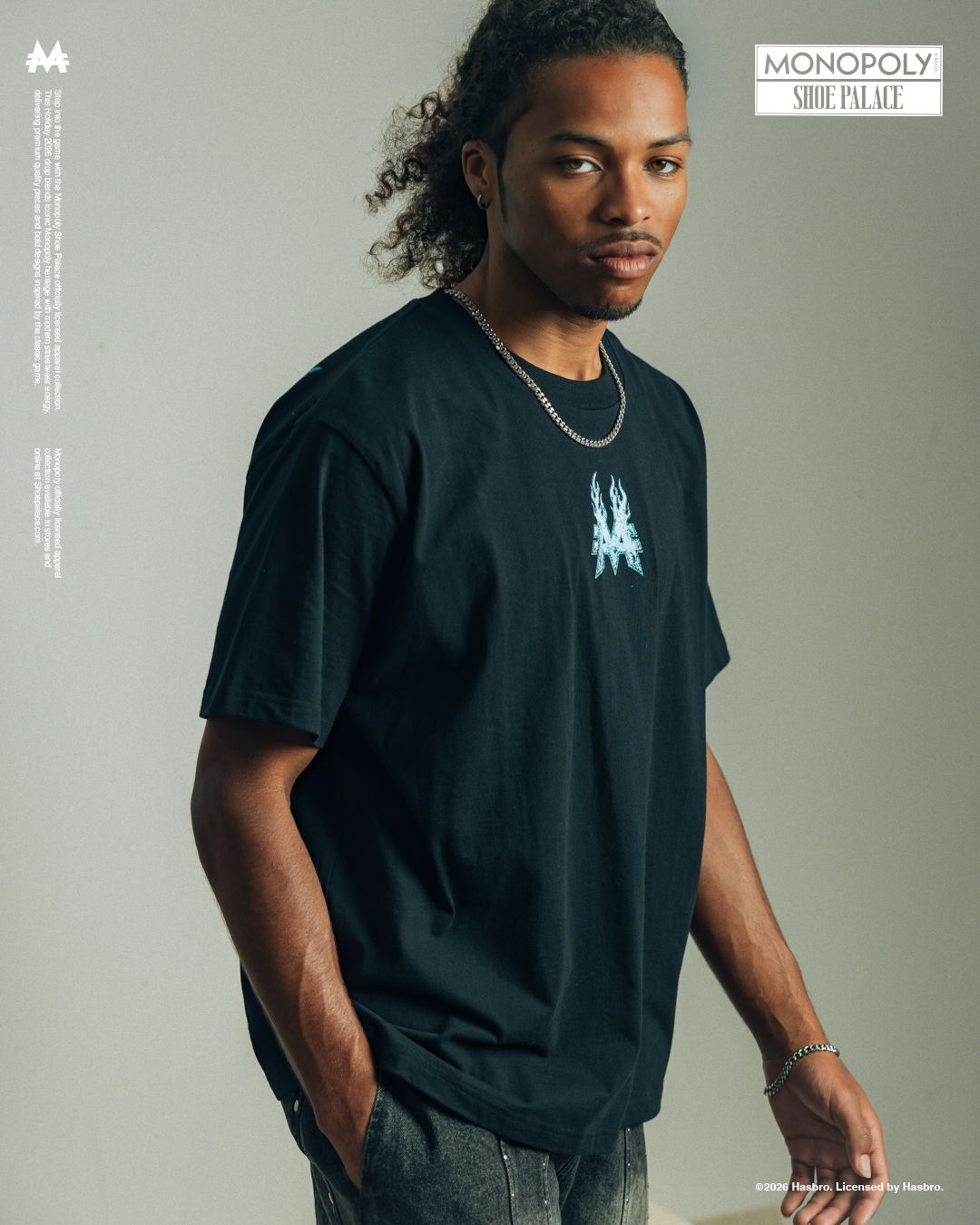 Young man wearing a black t-shirt with a graphic design.