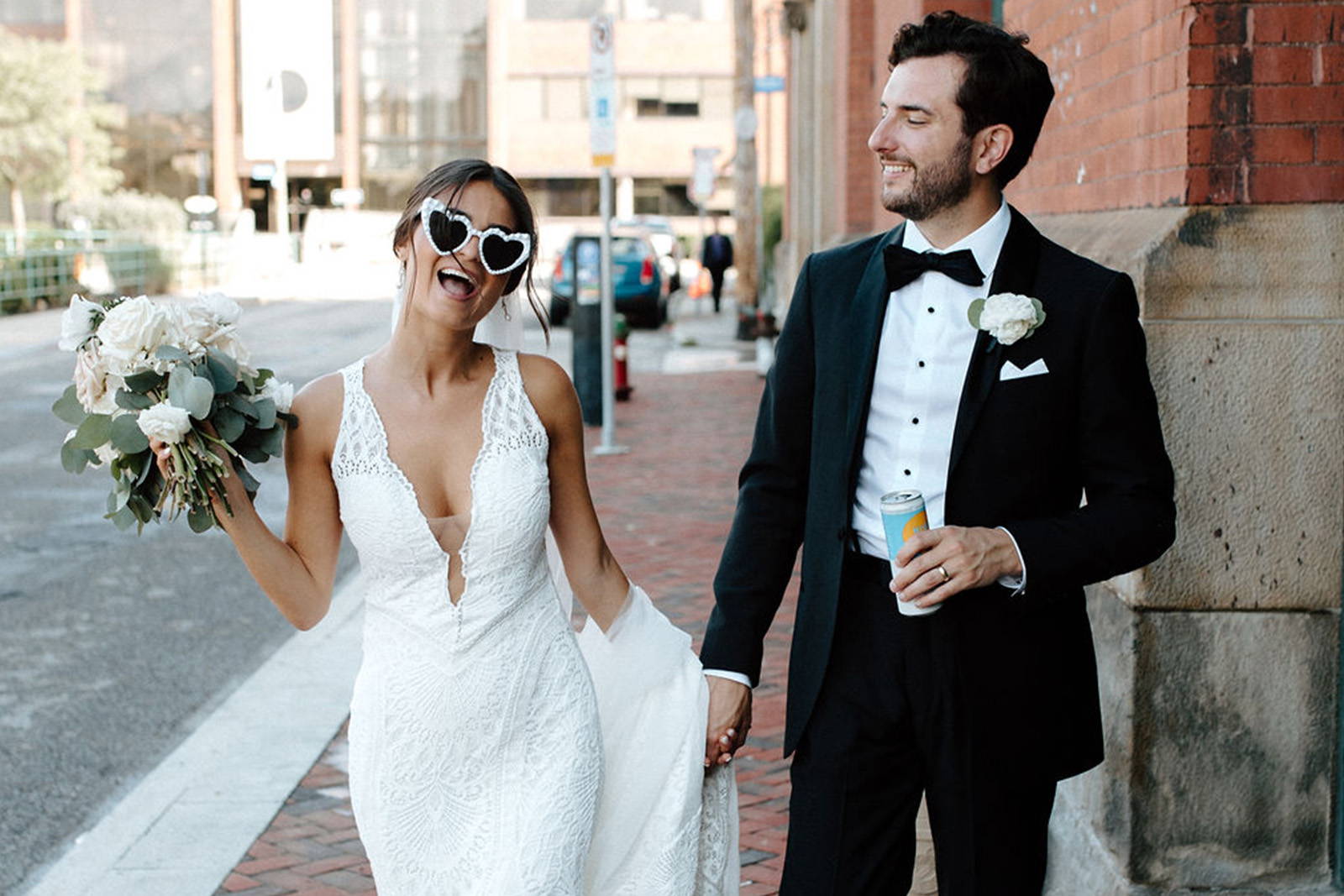 Bride in love heart sunglasses wearing the Chelo gown