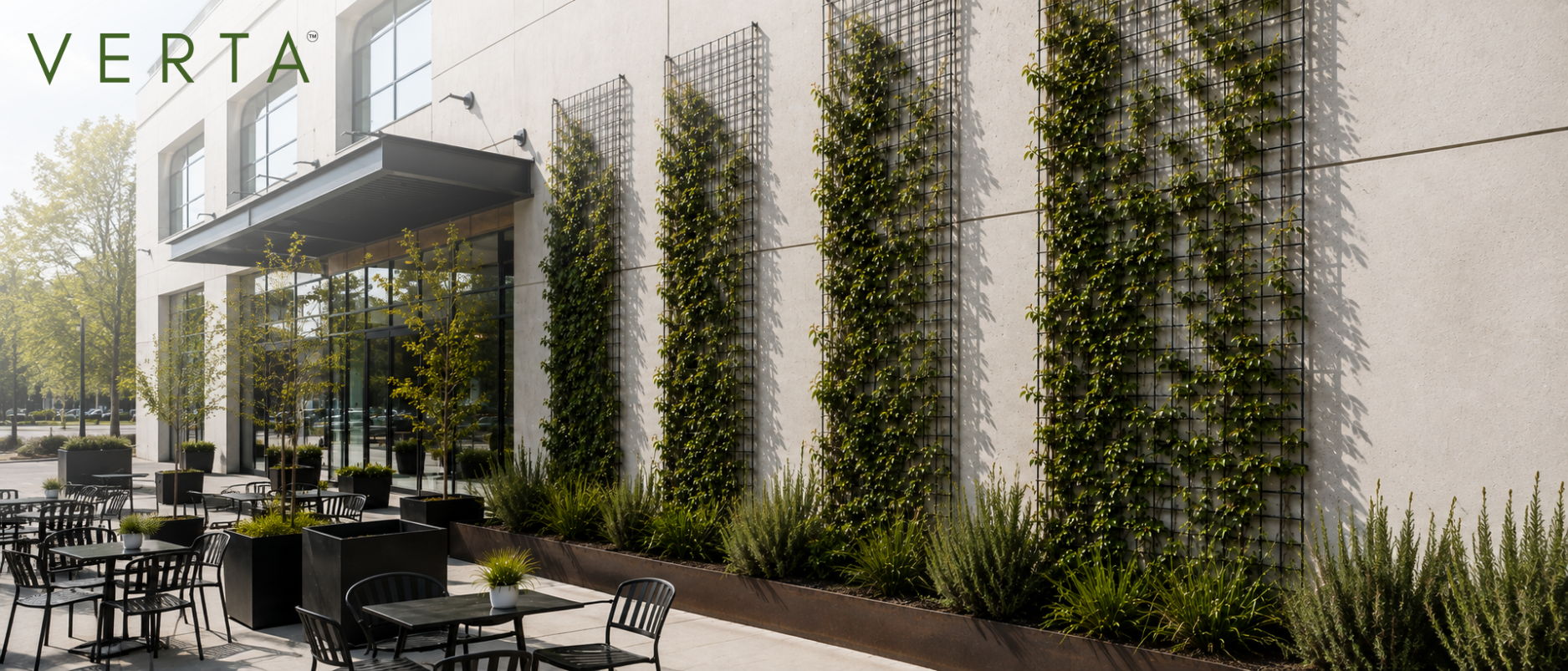 Corten steel modwall with plants and trellises on a modern building exterior with outdoor seating area.