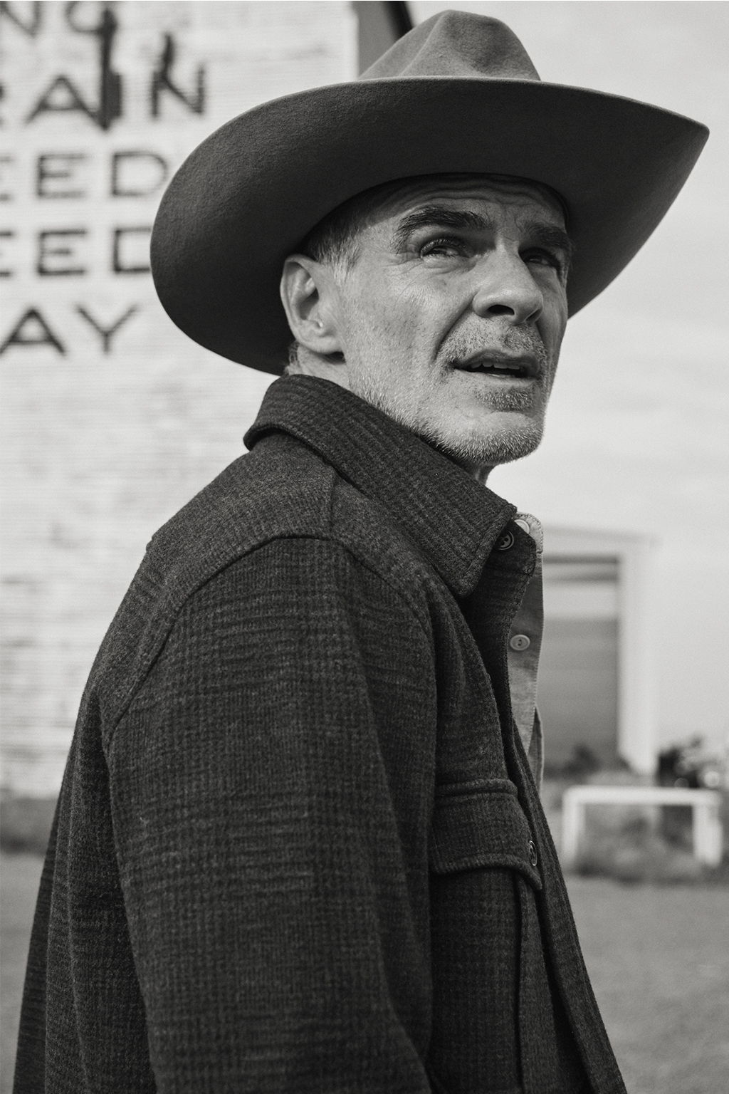Black and White portrait of Michael Kelly wearing the Meade Wool Glen Plaid Overshirt in Olive Drab in Livingston, Montana