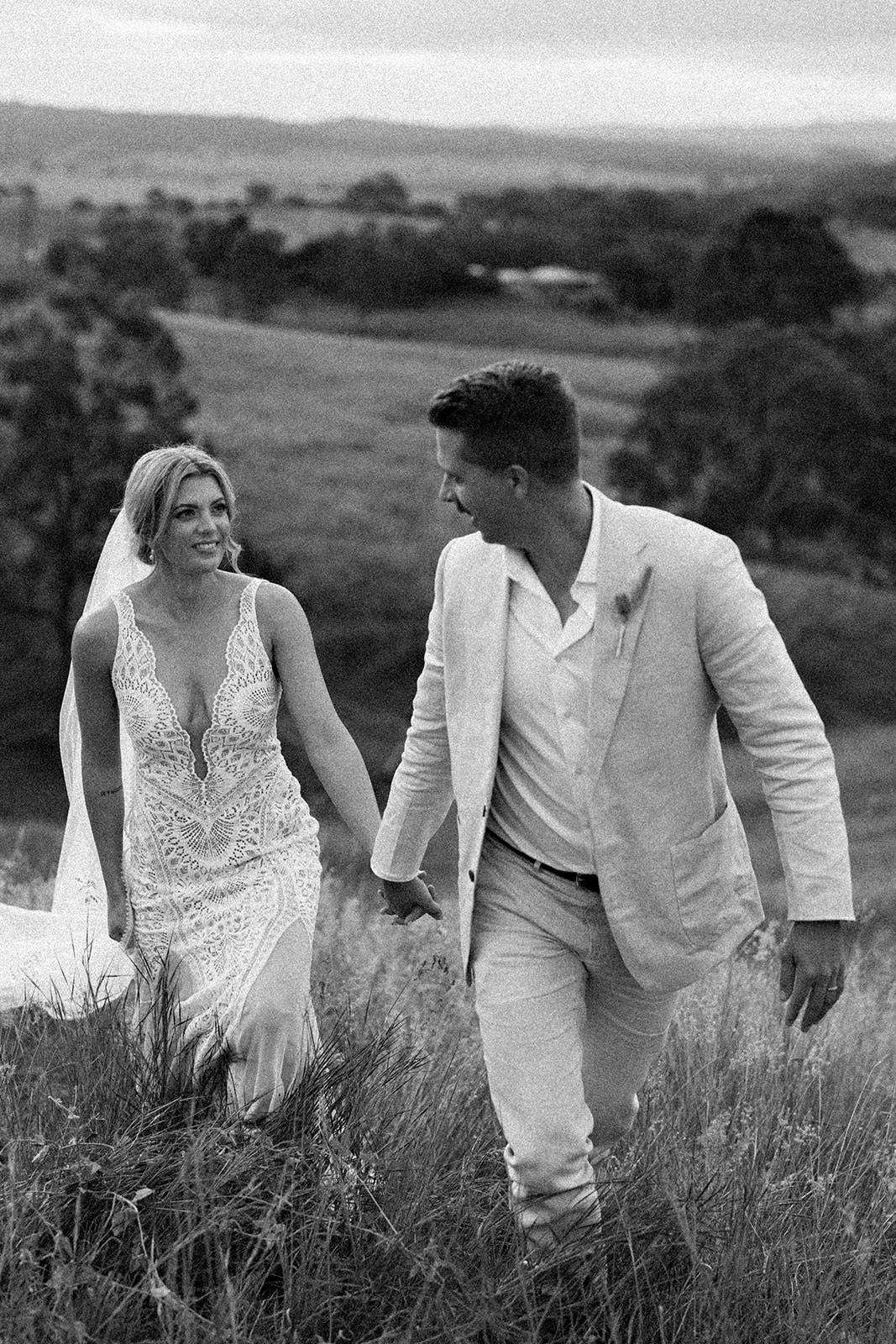 Bride and Groom walking up hill