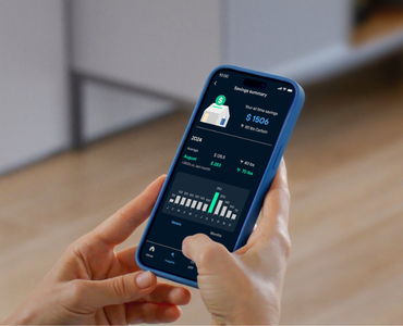 Person holding a smartphone displaying Lunar Energy's home energy data.