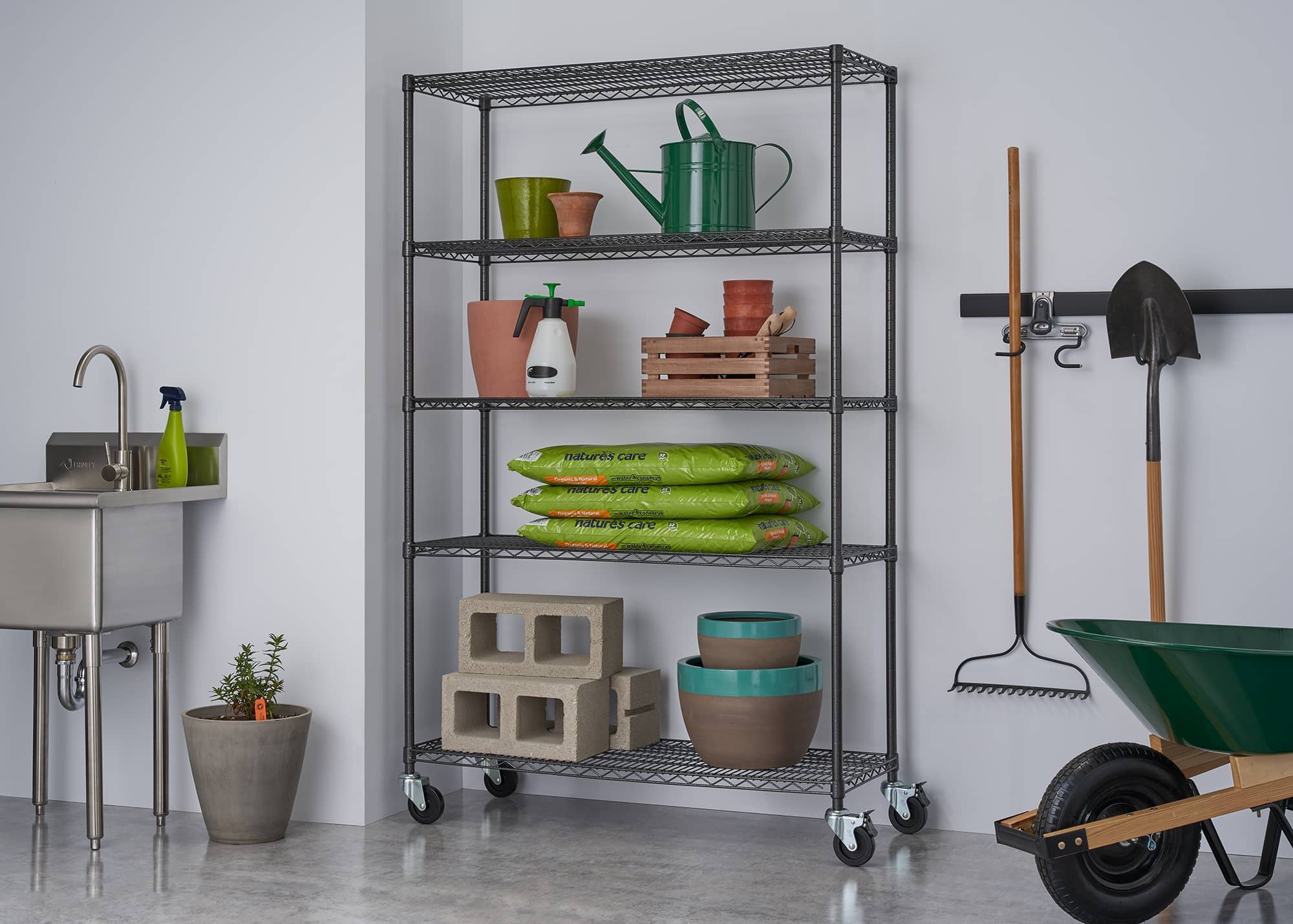 heavy duty garage wire shelving rack with wheels filled with gardening and other construction materials