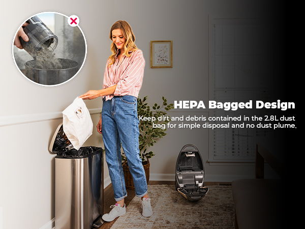 Woman disposing of dust into a trash can, demonstrating HEPA bagged design.