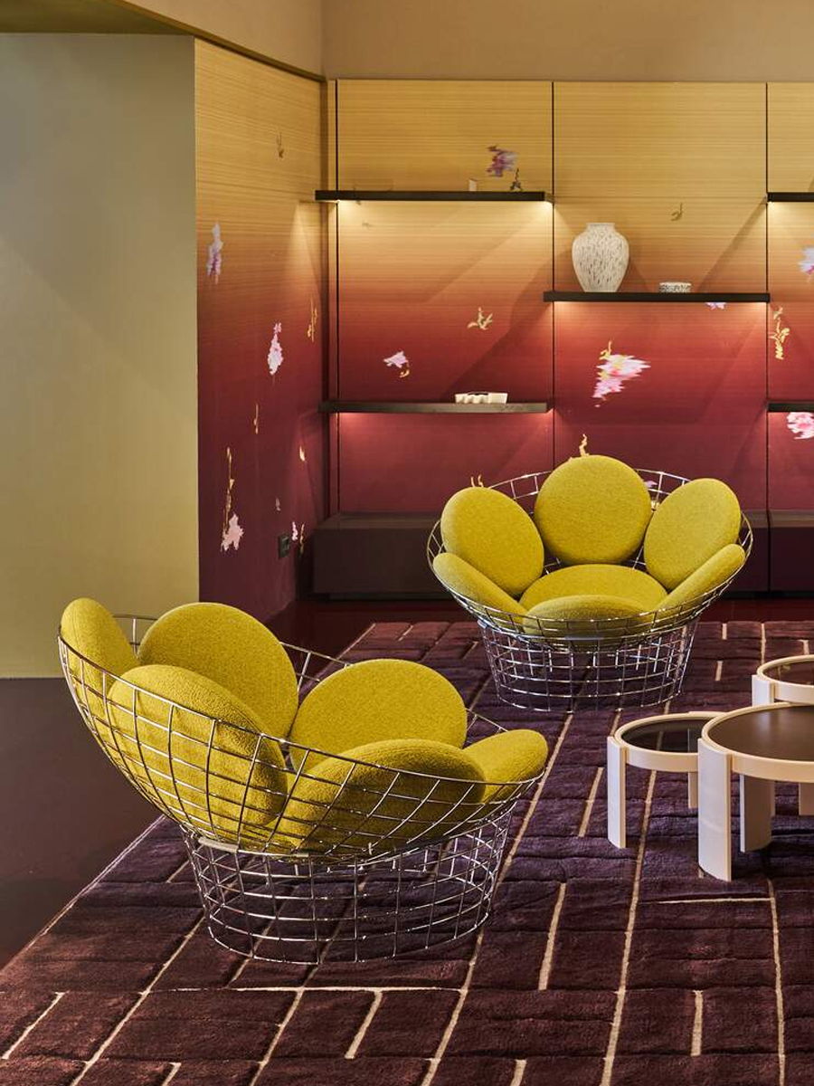 Two yellow PEACOCK chairs in a modern interior space.