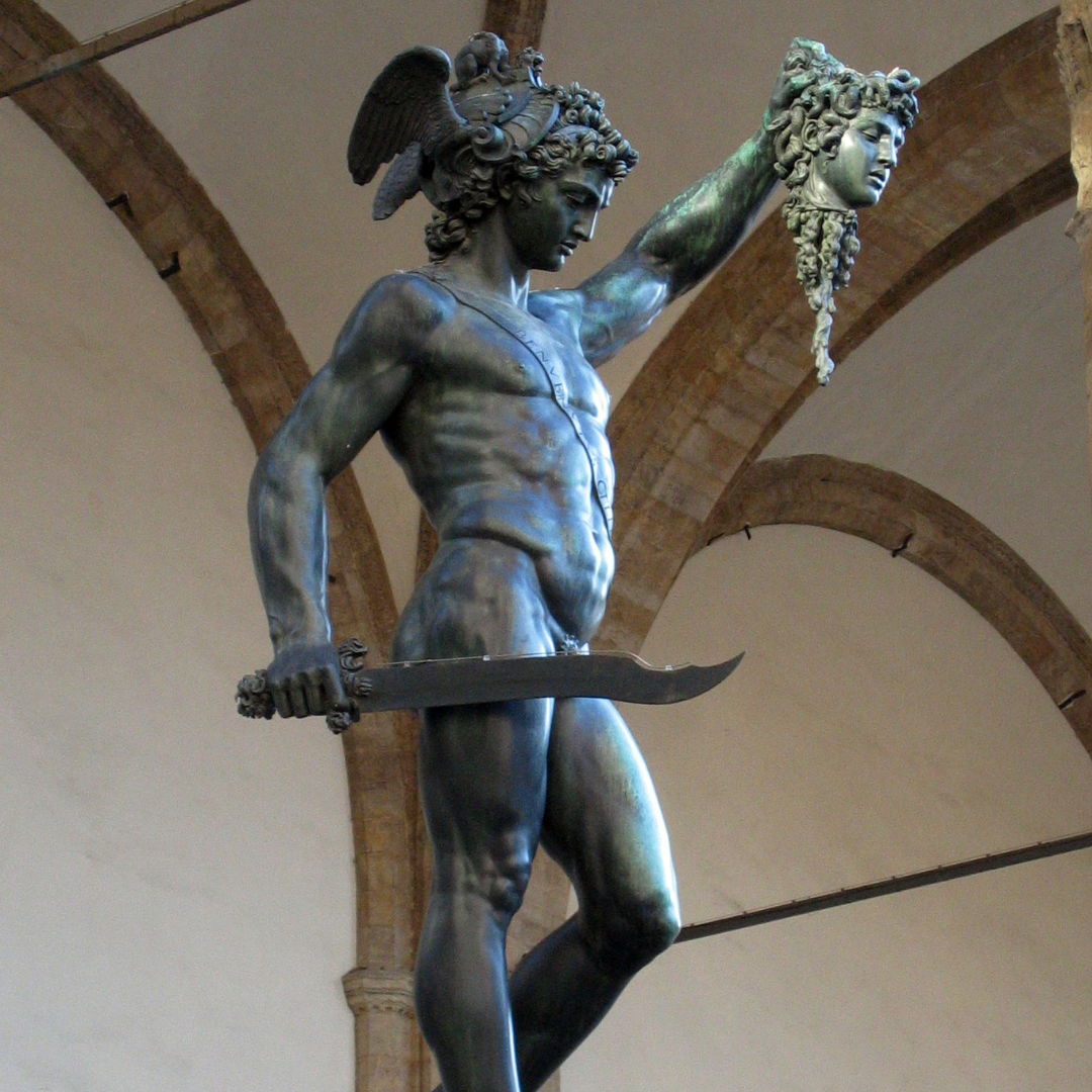 Statue of Perseus holding Medusa's head and a sword.