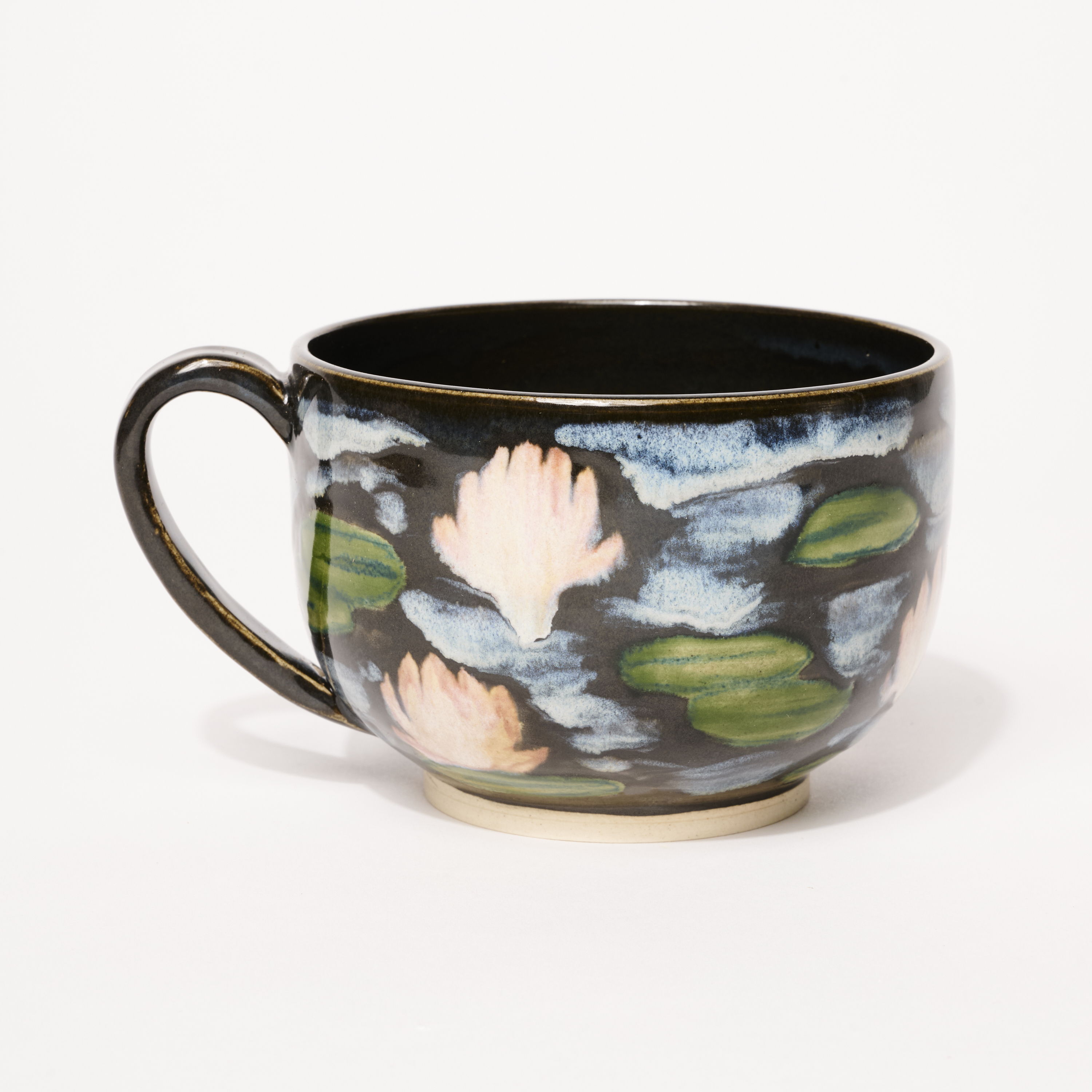 A decorative cup with floral patterns on a dark background.
