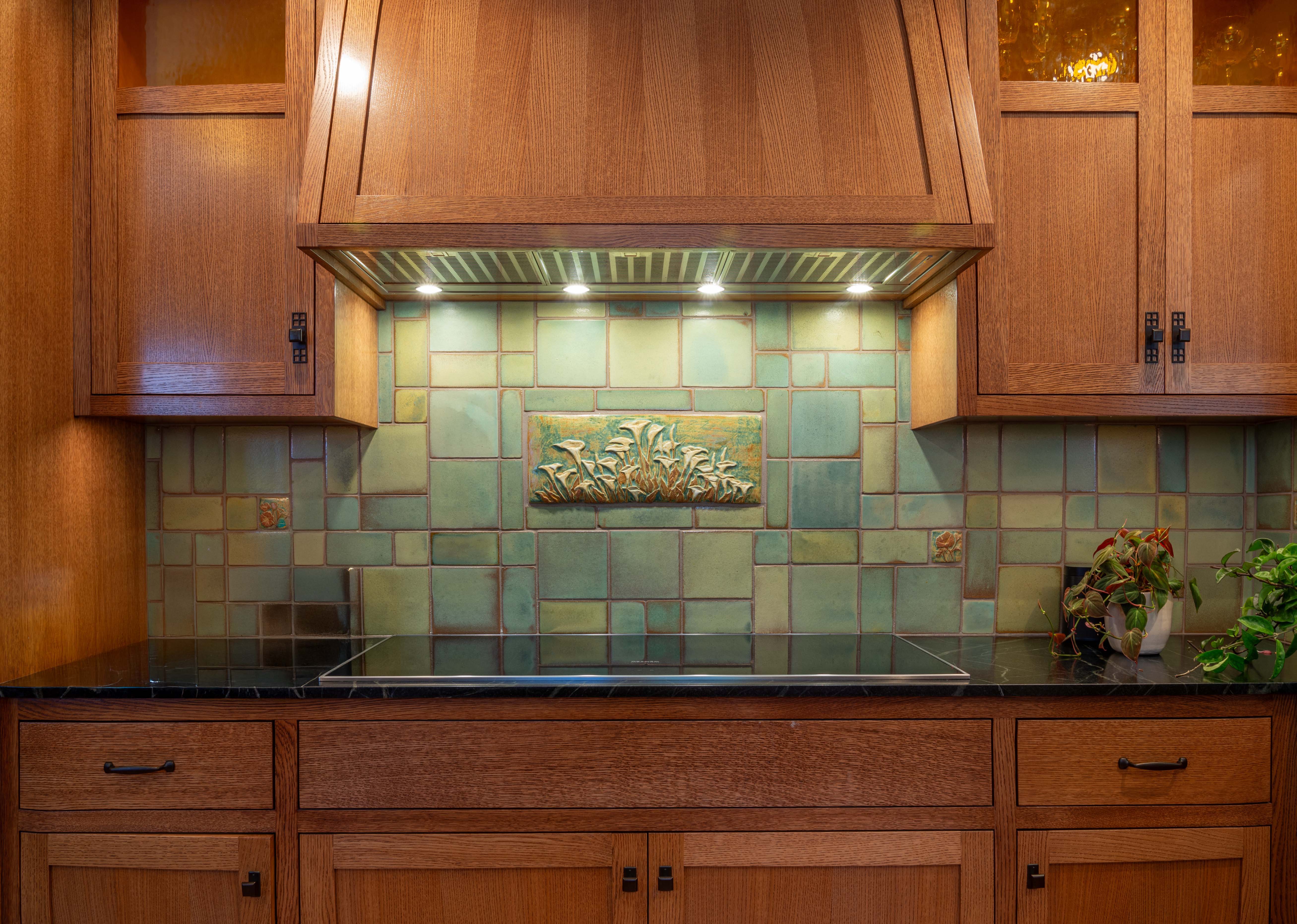 A Craftsman kitchen range with a tile backsplash by Pasadena Craftsman Tile artist Cha-Rie Tang.