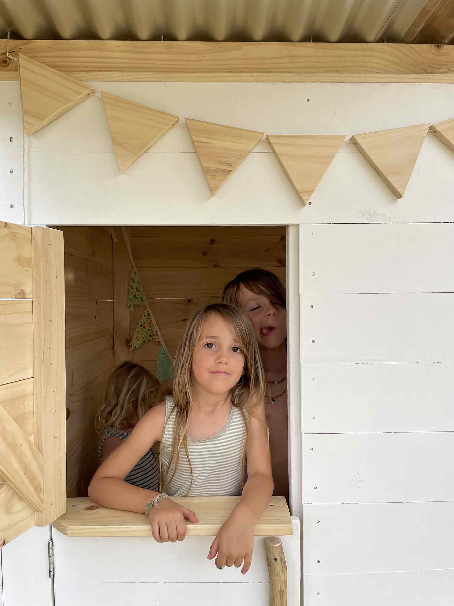 Kids playing in their timber cubby house
