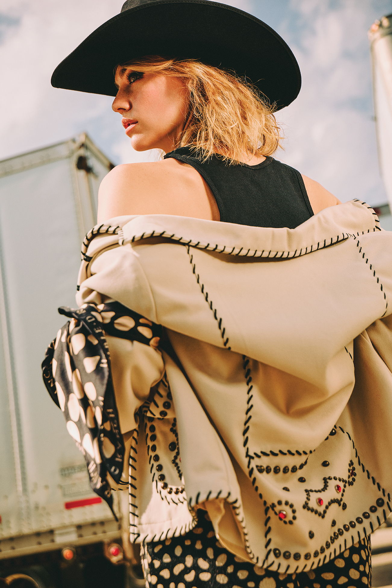 Lozzie wearing the Underground Hootenanny Jacket with the Howdy Dotty Scarf tied around her arm with the Howdy Dotty shorts.