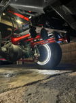 Night view of red train horns and compressor with illuminated wheel ring under lifted truck