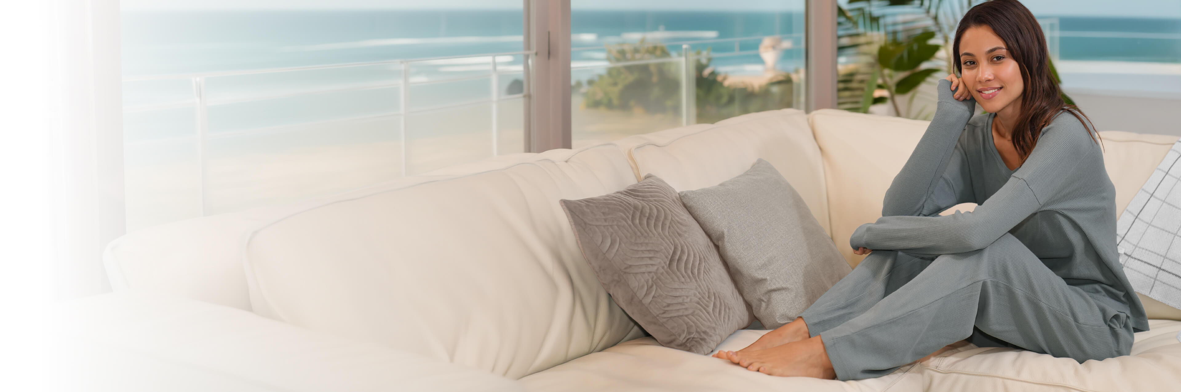 a woman lying in bed with bamboo sheets. 