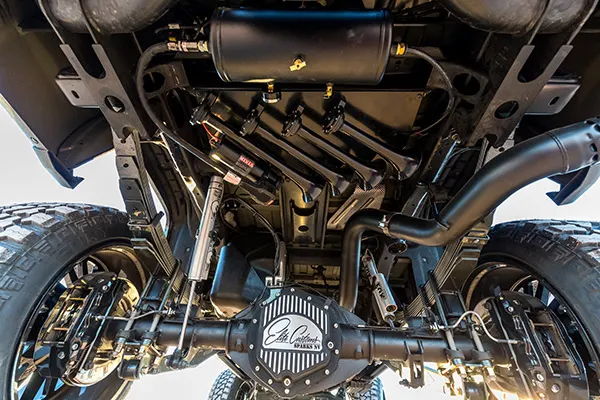 Undercarriage view of black Nathan-style train horn bells with black air tank mounted on Elias's 2015 Chevy Silverado 2500HD, install photo 2