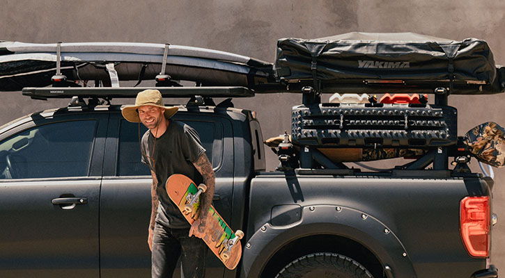 Man in front of ute with tub roof rack and accessories