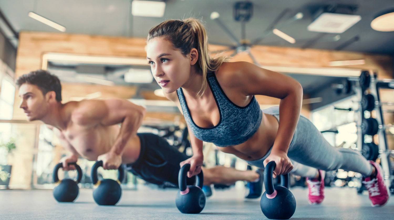 Young couple is working out at gym | Protein Powder Isolate vs. Concentrate: Which Is the Healthiest? | milk protein | Featured