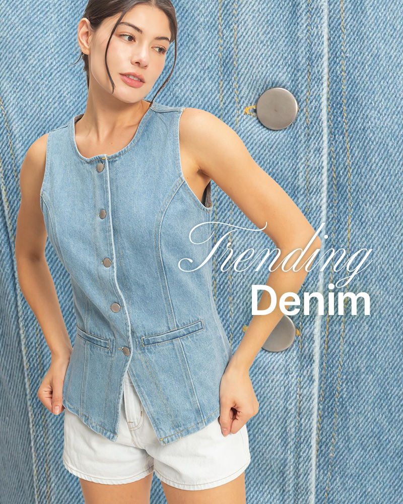 Woman wearing a denim vest with shorts, against a denim background.