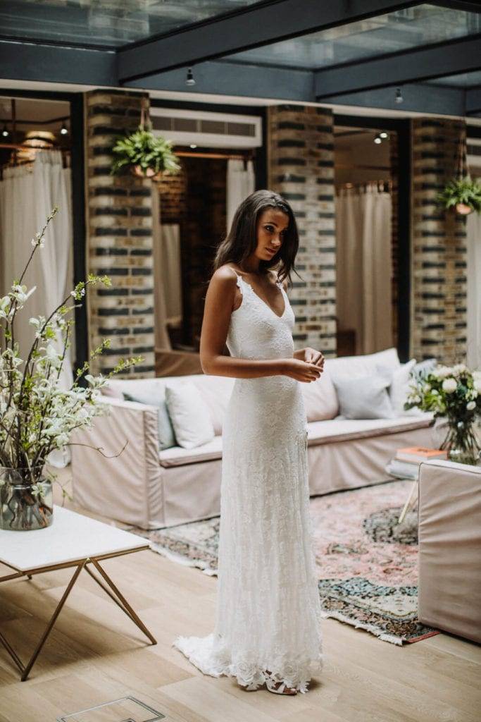 Bride wearing a white lace dress inside the Grace Loves Lace bridal showroom in London