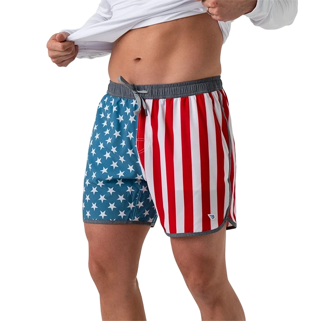 Man wearing patriotic swim trunks with American flag design.