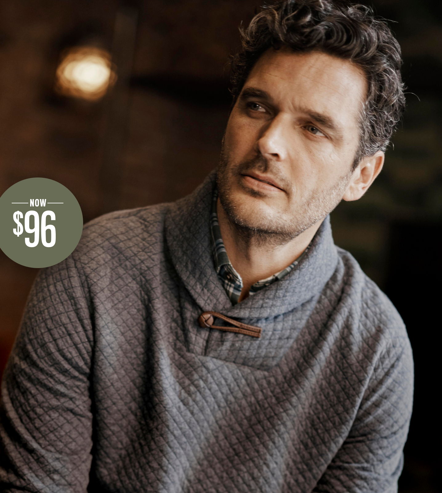 Man wearing a gray sweater, looking thoughtfully, with a price tag of $96.