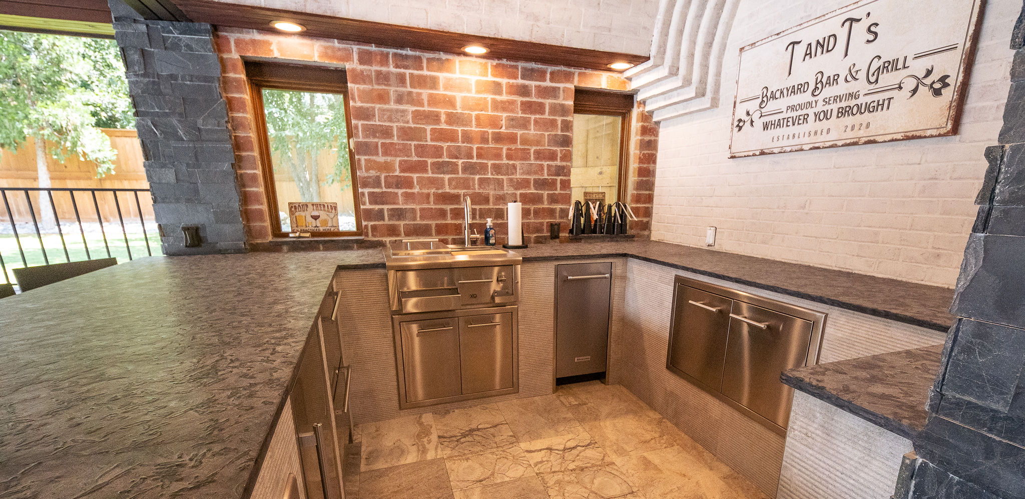 Modern kitchen with wooden cabinets and stone accents, featuring a spacious countertop.