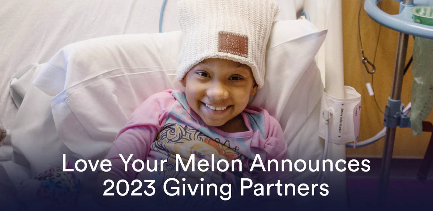 Young girl in a hospital bed wearing a Love Your Melon beanie