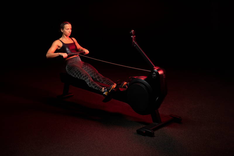Female rowing on Heat Row exercise machine