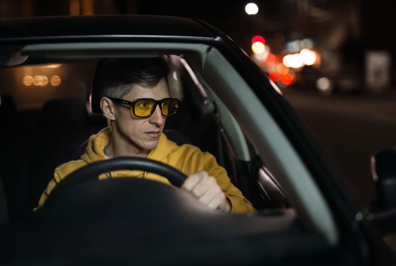 Man wearing Kaya eyeglasses with yellow lenses for night driving