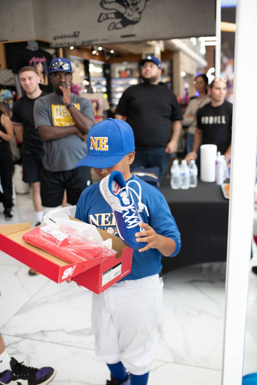 kid opening new balance shoes