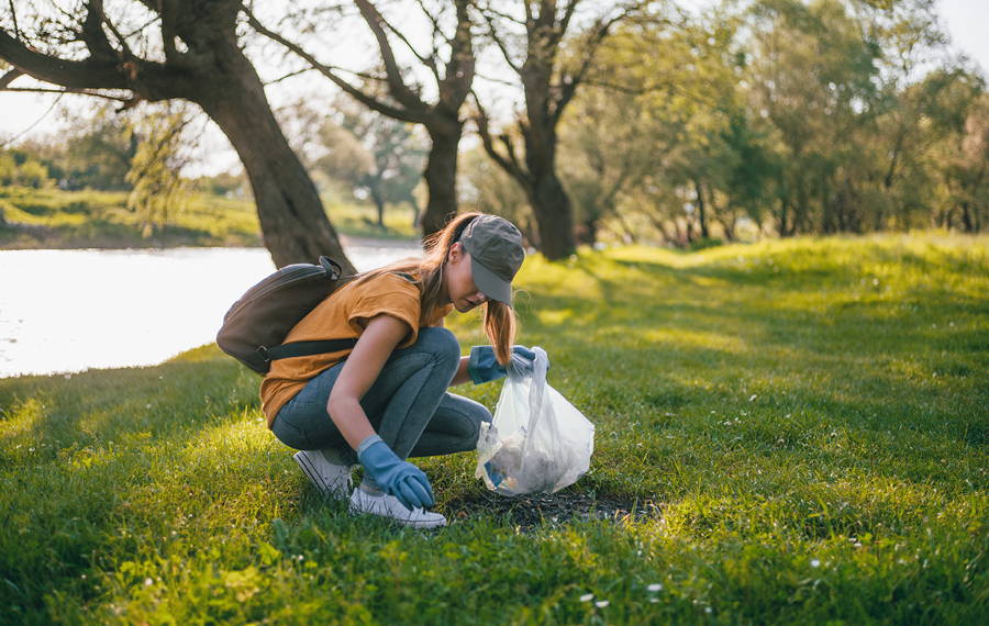 woman in park cleaning up trash