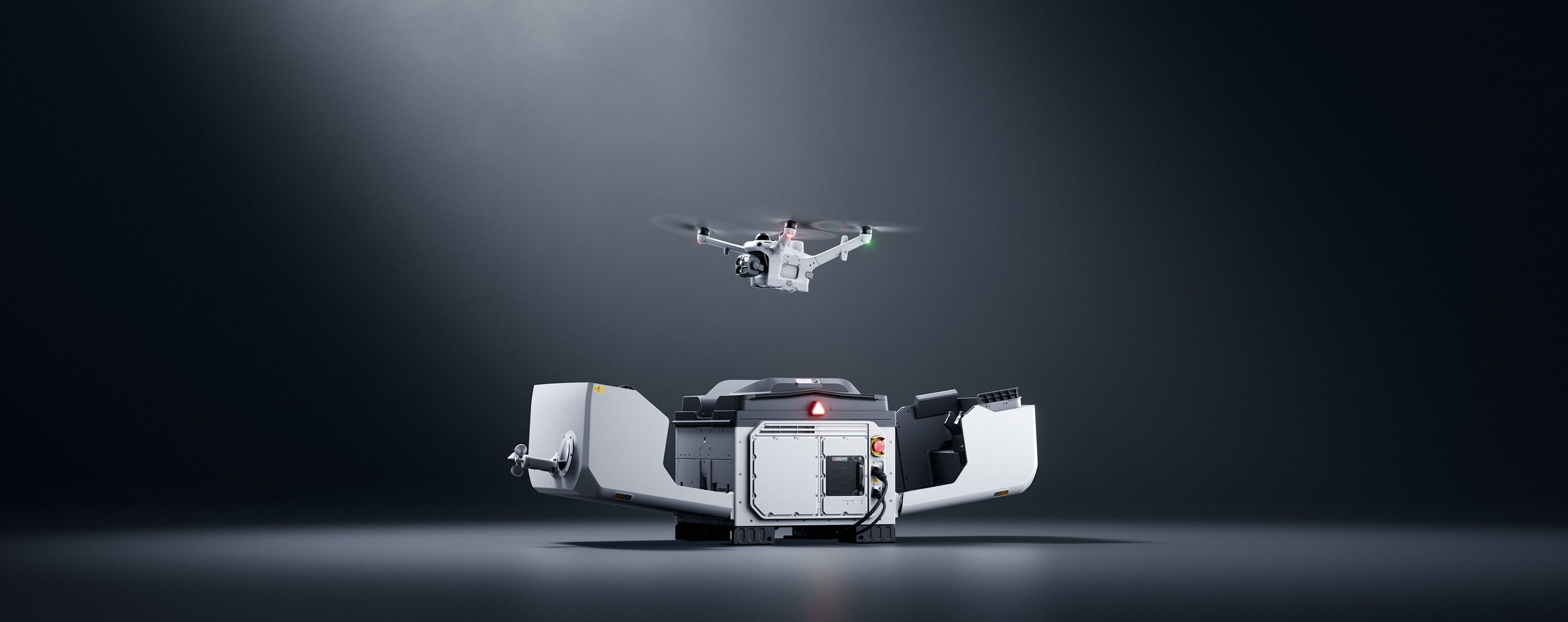A DJI Matrice 5TD drone hovering above a DJI Dock 4 in a dark environment.