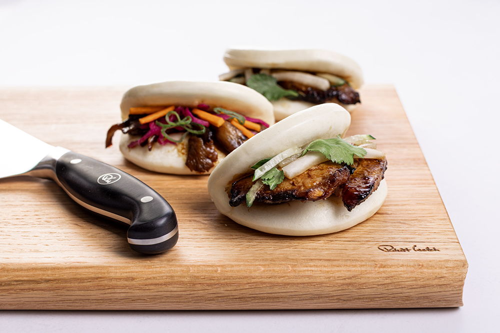 Three bao buns on a Robert Welch cutting board.