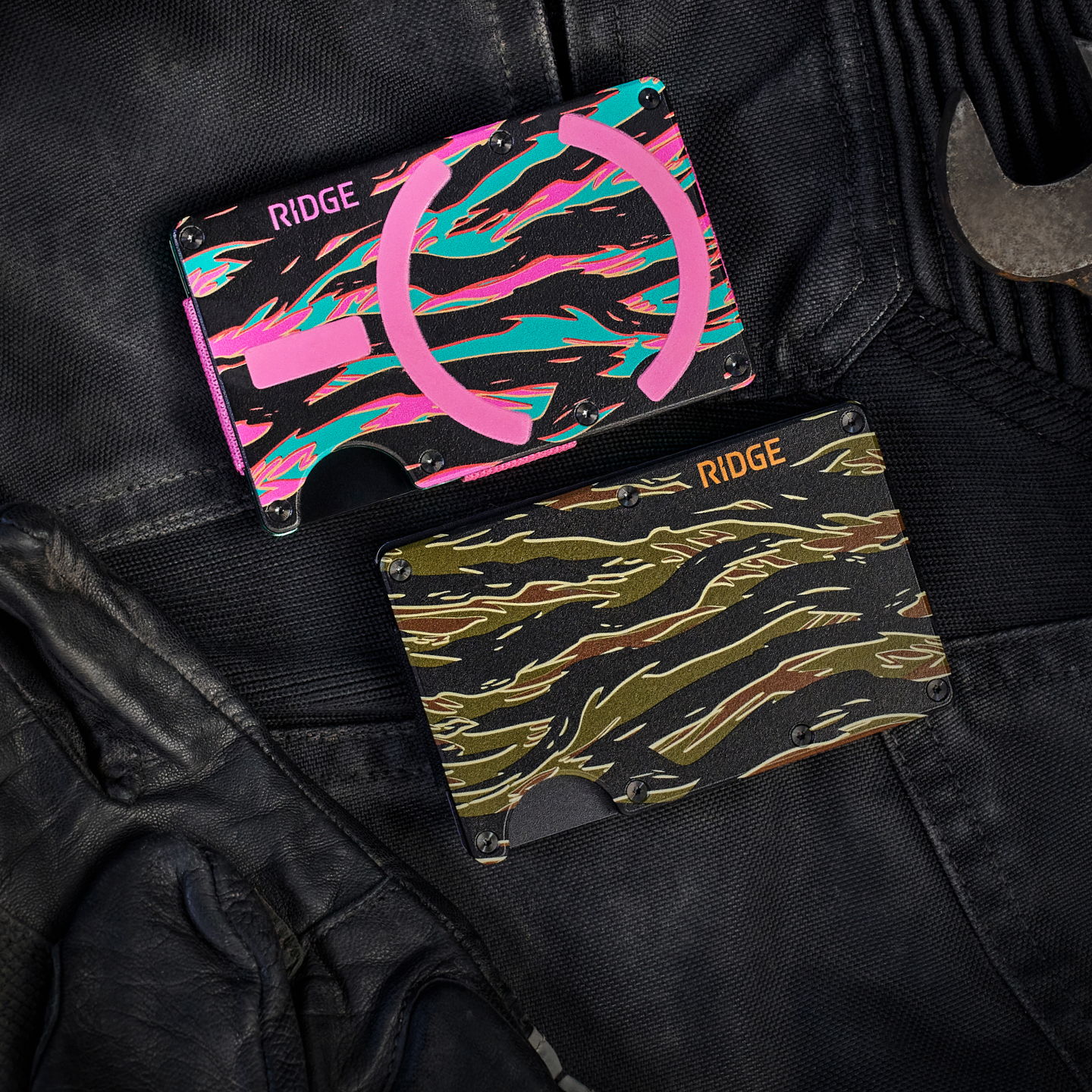 Two colorful wallets on a dark leather background.
