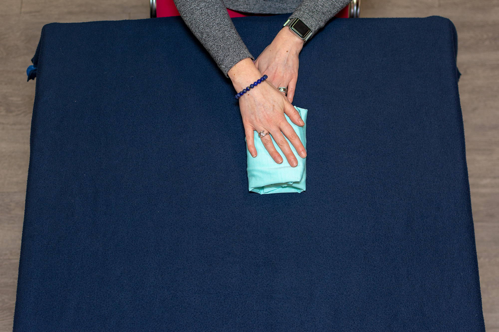 hands folding long-sleeved tee